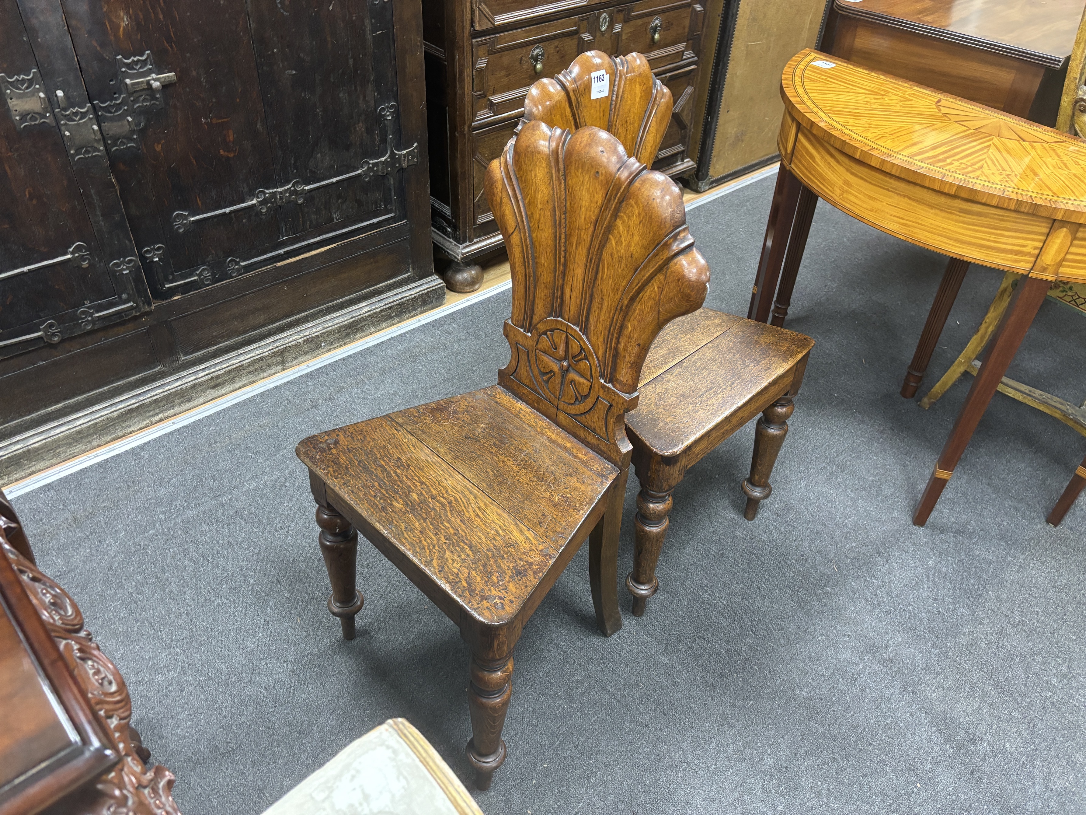 A pair of Victorian carved oak hall chairs, width 40cm, depth 40cm, height 87cm